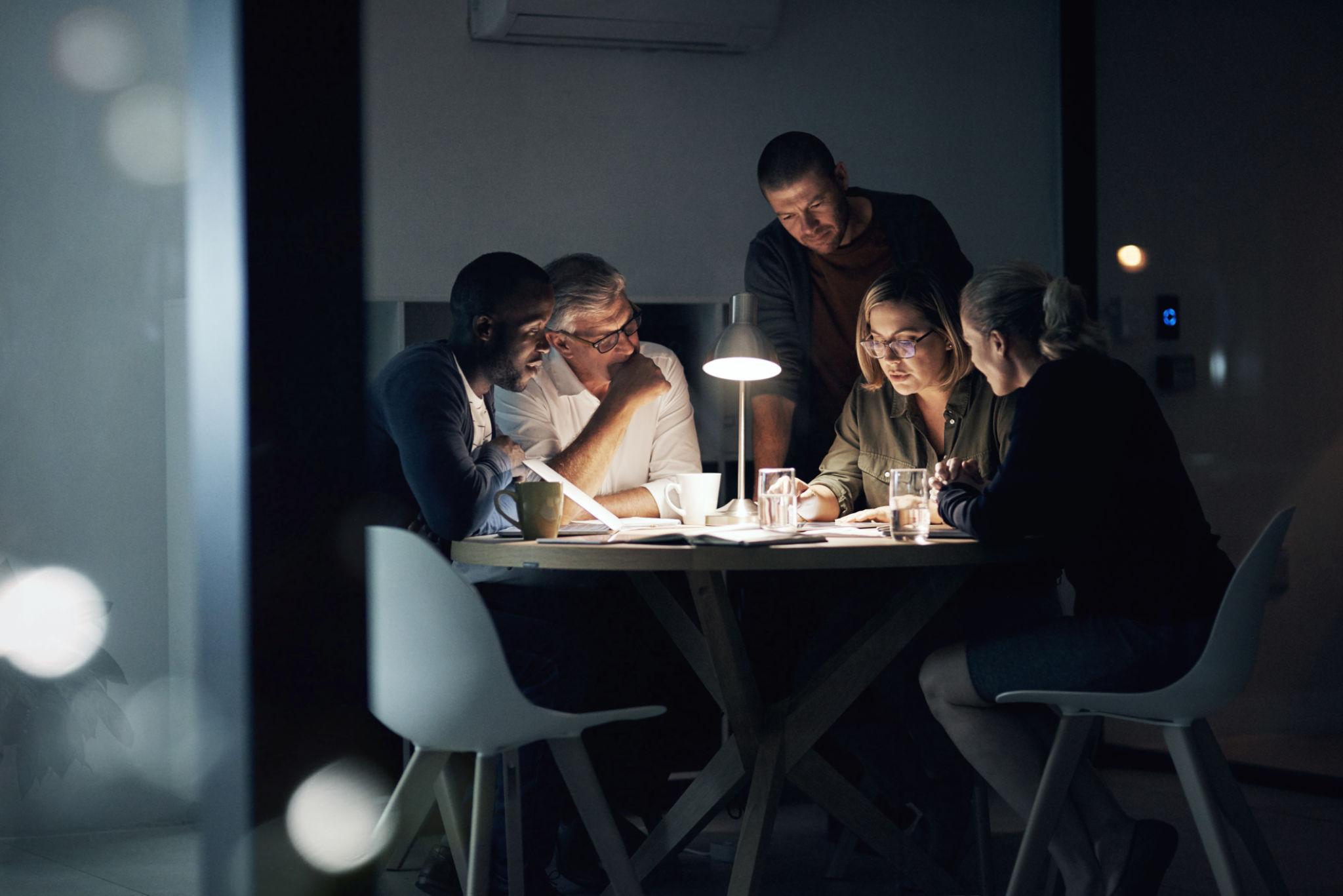 People reading documents together around a table.